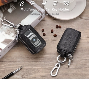 Macro shot of double-zippered lychee pattern leather car key case on a wooden desk