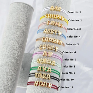 18K gold-plated bubble letter pendants on colorful cord bracelets for DIY jewelry making