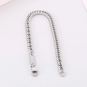 Detailed view of silver stainless steel Cuban link chain with rectangular pendant and clasp