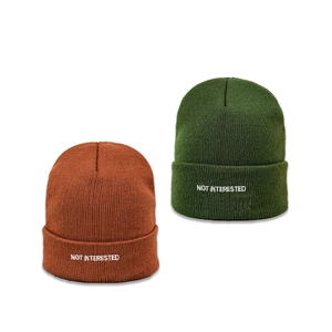 Caramel and forest green ribbed beanies with white Not Interested embroidered slogan