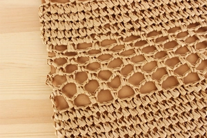 Macro detail of hand-woven paper rope bag featuring honeycomb texture and inner lining