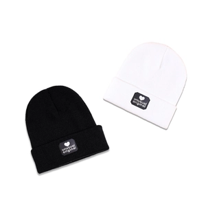 Unusual original knitted beanie hats in black and white with heart pattern label