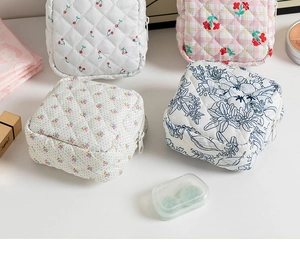 Detailed set of four quilted cotton pouches in cherry, floral, dot, and calico patterns