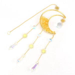Detail of moon suncatcher with raw crystal stones and colorful faceted prisms