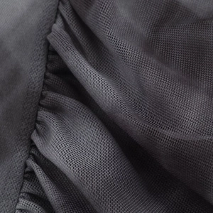 Detailed macro view of black sheer mesh fabric with intricate pleating and ruching textures