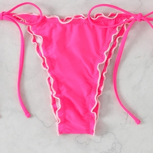 Flat lay of neon pink bikini bottoms with adjustable side ties and ruffled lettuce edges