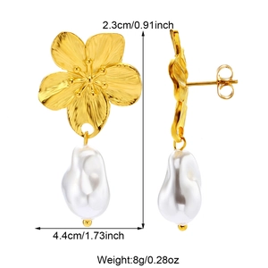 Detailed view of gold metal flower earrings with white pearls and size measurements