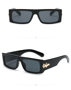 Detail view of rectangular black sunglasses with gothic golden metal temple accents