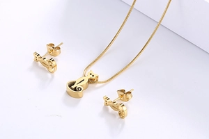 Detailed view of gold stainless steel hollow cat pendant necklace and stud earrings set