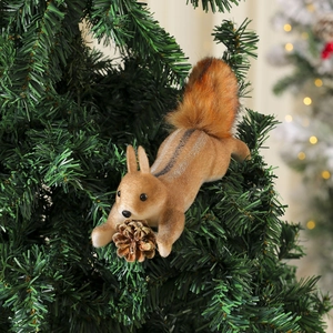 Detail of creative foam squirrel ornament with pine cone on green Christmas tree branch