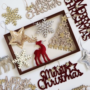 Red flocked reindeer and golden stars Christmas ornaments set in a wooden frame