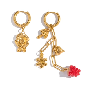 Detailed view of asymmetric gold-plated earrings with floral and fruit charms on white background