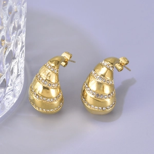 Detailed view of gold teardrop earrings featuring four rows of inlaid white rhinestones