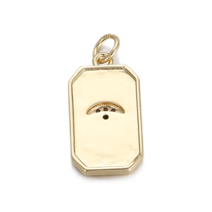 Detail shot of a rectangular gold-plated pendant with crescent moon and dot cut-outs