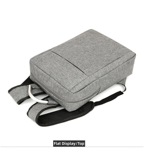 Detail view of grey travel backpack with metal handle and breathable mesh shoulder straps