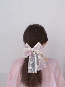 Detailed back view of a large lace embroidery bow hair clip in lavender and cream mesh