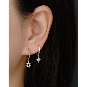 Close-up of S925 sterling silver star hoop earrings with diamond accents on a model