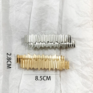 Detailed size view of gold and silver wave hair clips measuring 8.5cm by 2.8cm