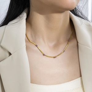 Detail of 18K gold plated blade chain with sparkling purple rectangle zircon stones
