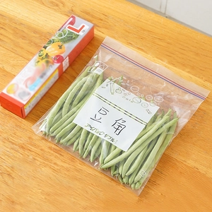 Thickened transparent freezer bag for food storage with fresh beans on a wooden table