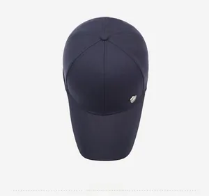 Top view of navy blue baseball cap showing six-panel stitching and metal side shield