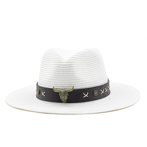 Detailed shot of white straw fedora featuring a leather band with bull skull ornament