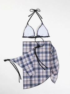 Detailed flat lay of a blue plaid three-piece bikini set with a matching sheer sarong