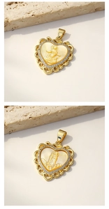 Detailed view of heart-shaped shell necklace pendant with gold-plated Madonna relief