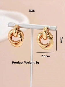 Detailed view of layered golden geometric hoop earrings with precise size measurements