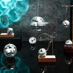 Silver mirror disco ball ornaments in various sizes with reflective square tiles