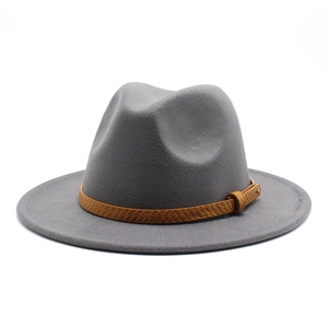 Detail of grey wool fedora hat with brown snakeskin leather band and gold metal rivet