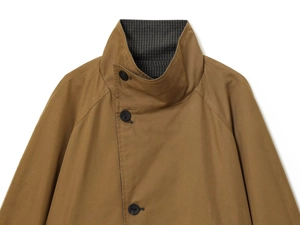Close-up of brown trench coat stand collar with three black buttons and striped lining