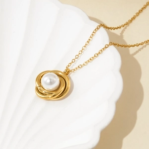 Elegant gold necklace with pearl pendant in a shell tray, luxury titanium steel jewelry