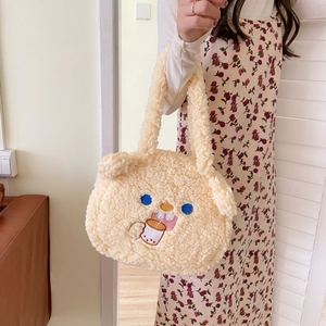 Detail of cute beige lamb wool tote bag with bear embroidery and soft double handles