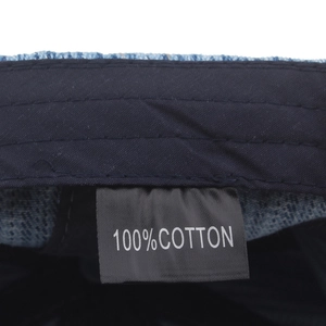 Internal detail of a 100% cotton blue denim newsboy cap with material tag and sweatband