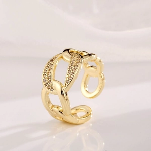 Detailed view of gold-plated chain link ring with micro-pave champagne zircons
