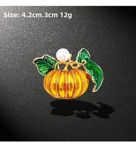 Detail of pumpkin brooch with yellow enamel, white pearl and 4.2cm x 3cm size measurement