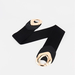 Women's black elastic waist belt with ornate double gold-tone metal buckle on white background