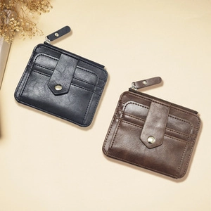 Detail view of retro PU leather shell-shaped coin purses in black and dark brown finish