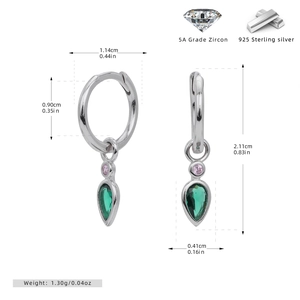 Macro detail of S925 sterling silver drop earrings with pear-shaped green zircon stones