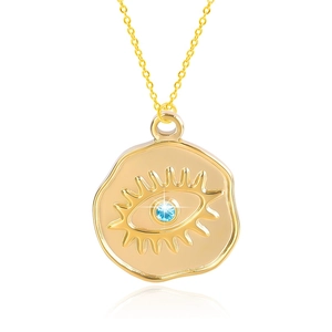 Macro shot of 18k gold plated evil eye pendant with blue gem and polished surface