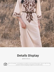 Detail of vintage ethnic embroidery on a cream linen dress with woven waist belt