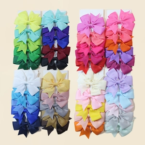 Colorful set of solid ribbed grosgrain ribbon bow hair clips on white card displays
