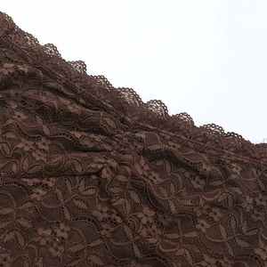 Gros plan sur le motif de dentelle marron et la texture du tissu de haute qualité