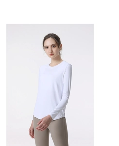 Detailed view of white long sleeve yoga t-shirt showing round neck and curved hemline