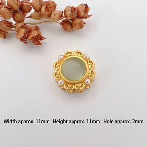 Macro shot of 11mm gold cat-eye bead with pearls for DIY jewelry making