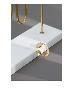 Detailed view of irregular vine texture and translucent bud stone on golden ring