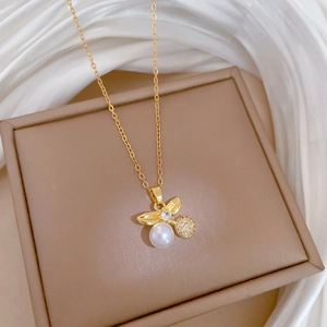 Close-up of pearl and diamond cherry pendant necklace on a premium brown jewelry box