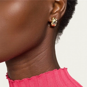 Luxurious gold rectangular stud earrings with white beads and black dots on model