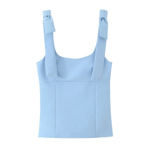 Detailed view of light blue camisole top featuring decorative shoulder ribbon bows
